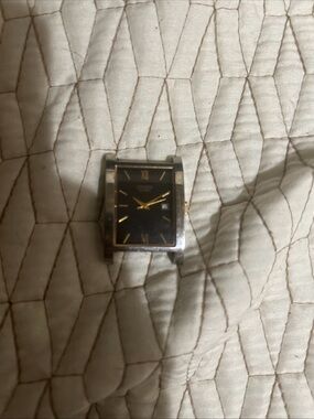 Citizen Rectangular Black Dial Watch with Gold Accents needs a battery